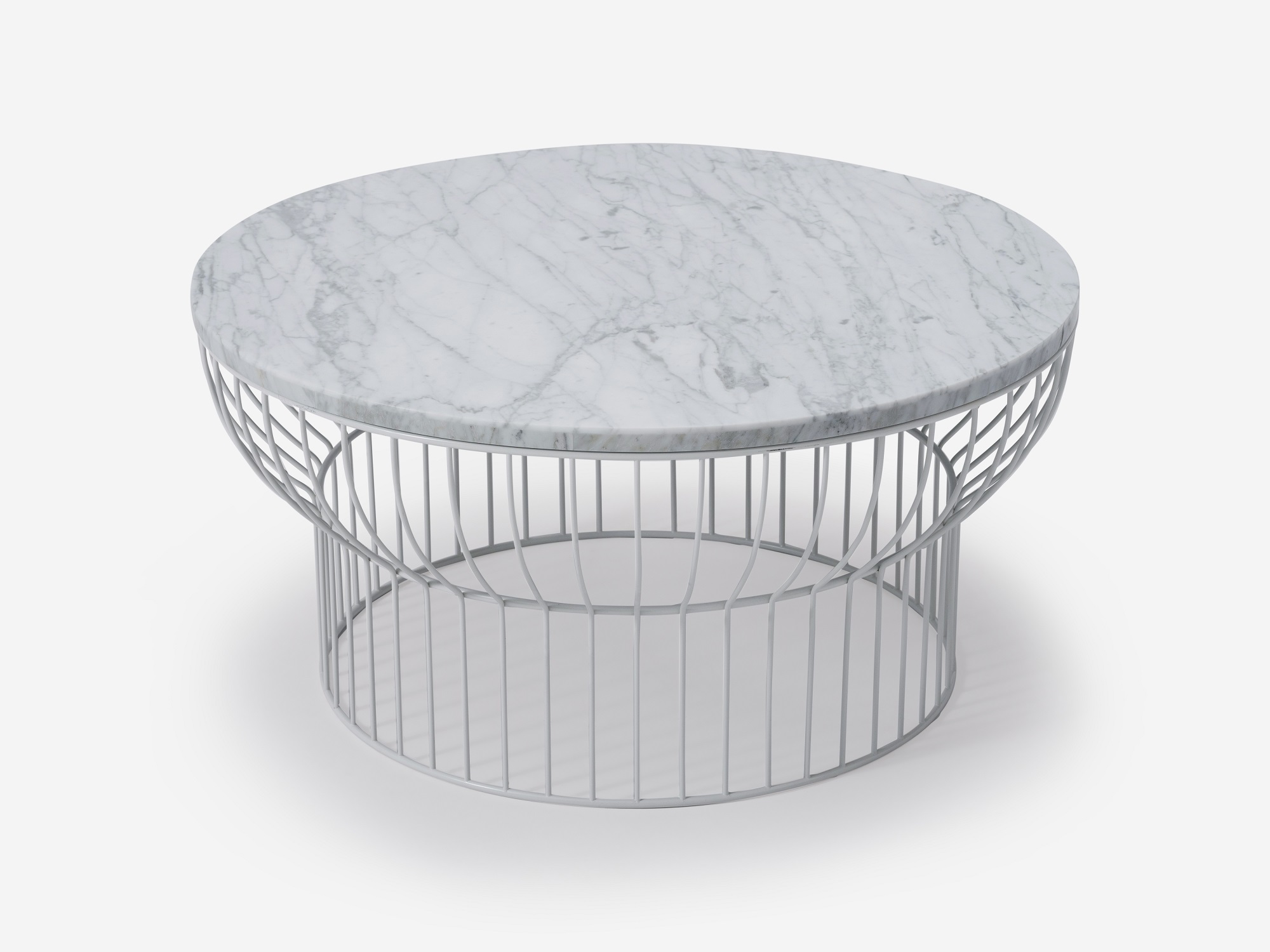 Detail view of round white wire coffee table with marble top